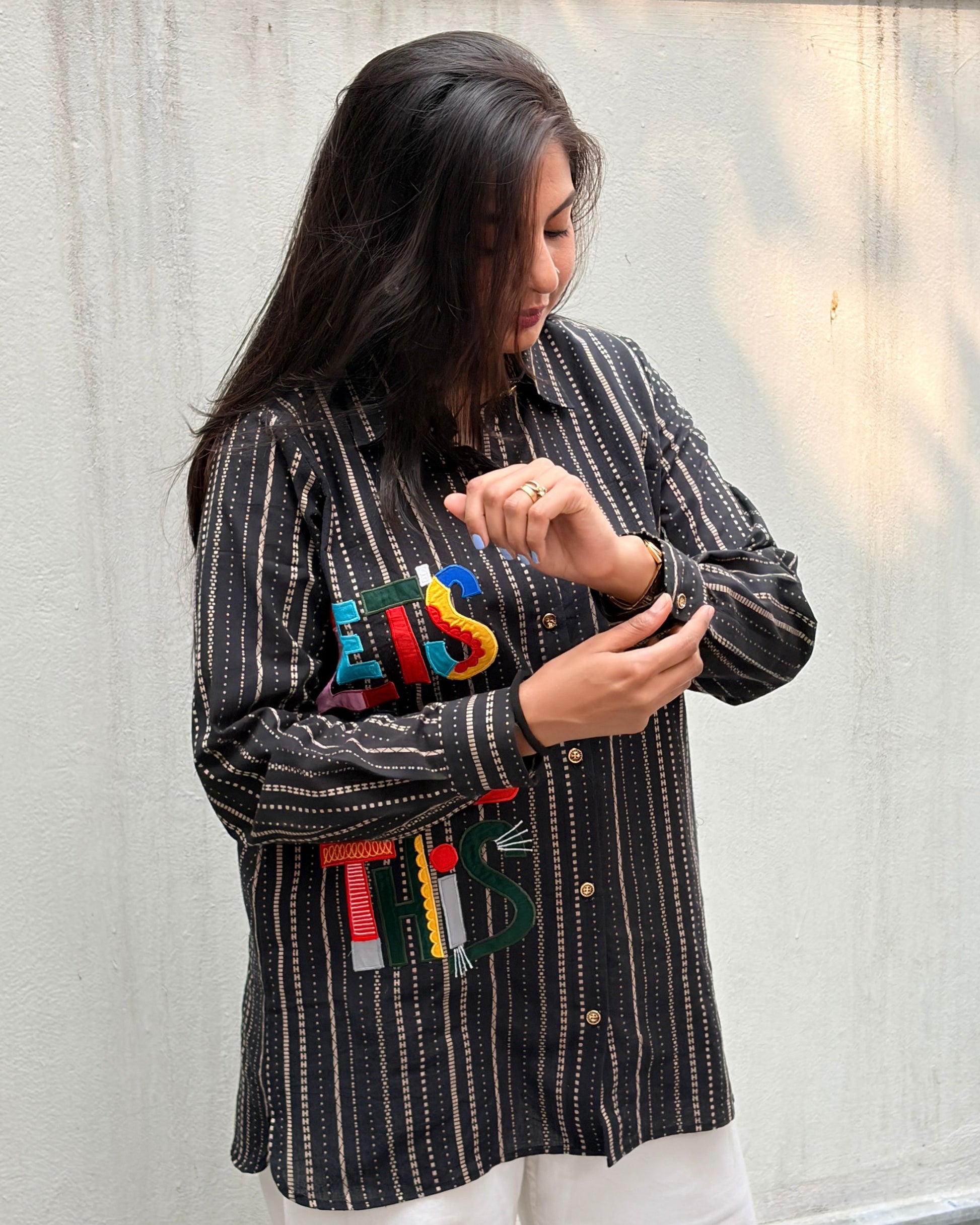 black shirt with colourful applique